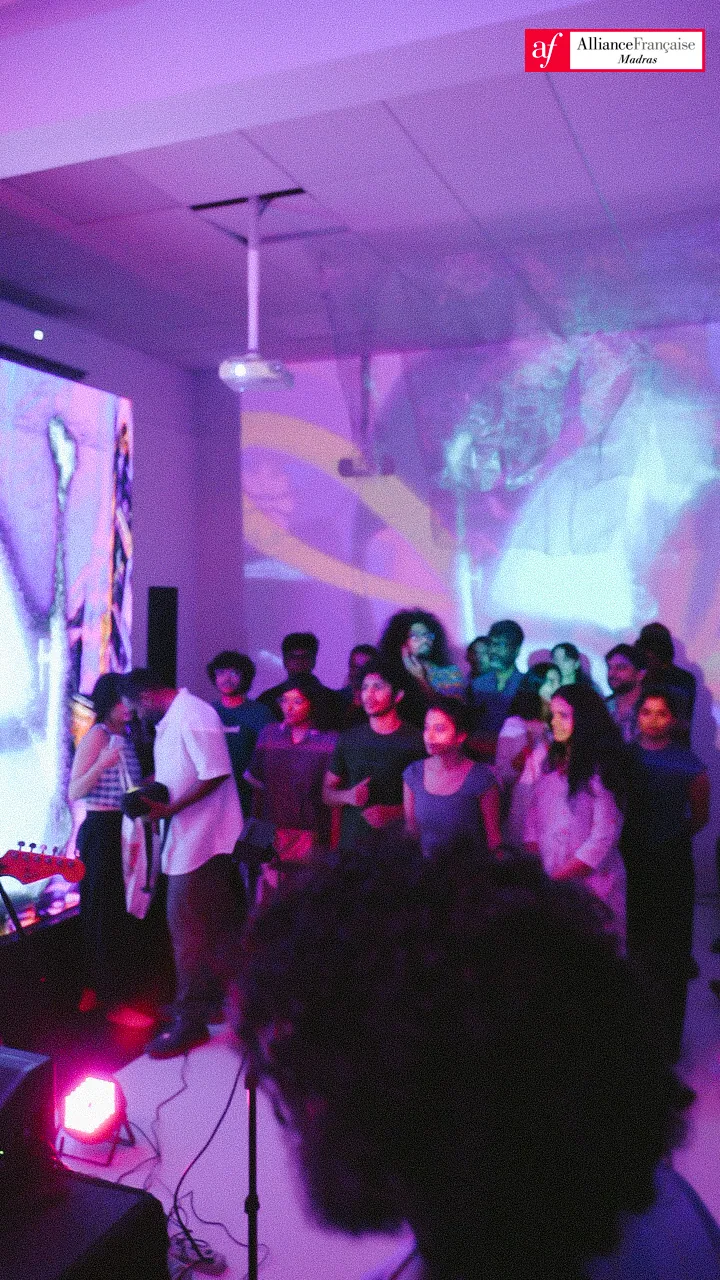 Audience and projections filling the venue.