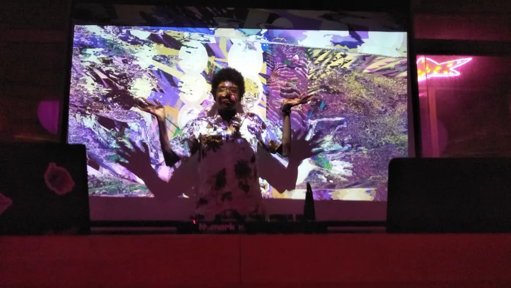 Performer silhouetted against responsive projection.